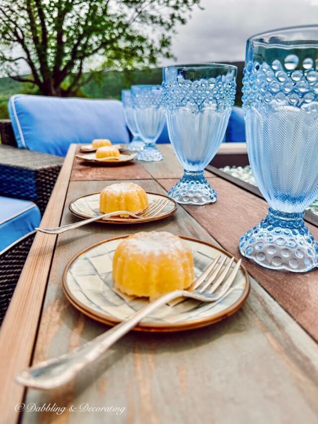 Lemon LuLu Cakes on dessert plates around outdoor fire pit.