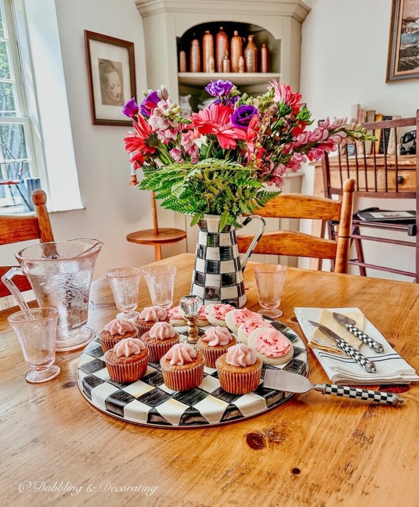 MacKenzie-Childs Courtly Check Pitcher of flowers and cheese tray with desserts