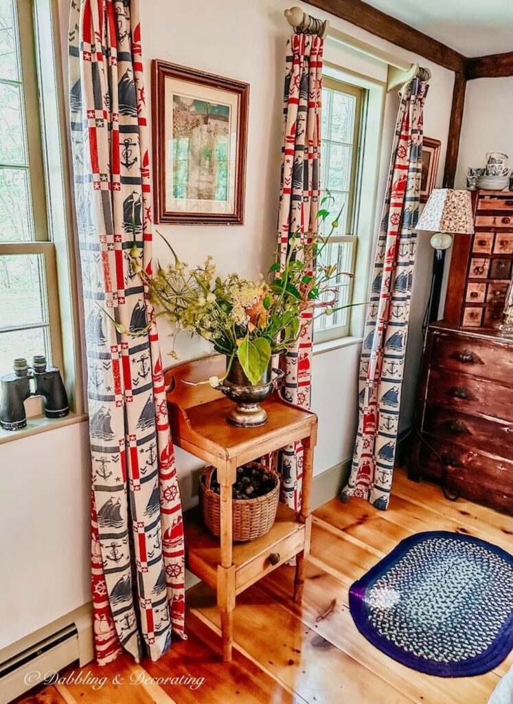 Antique Table with Flowers in Corner.