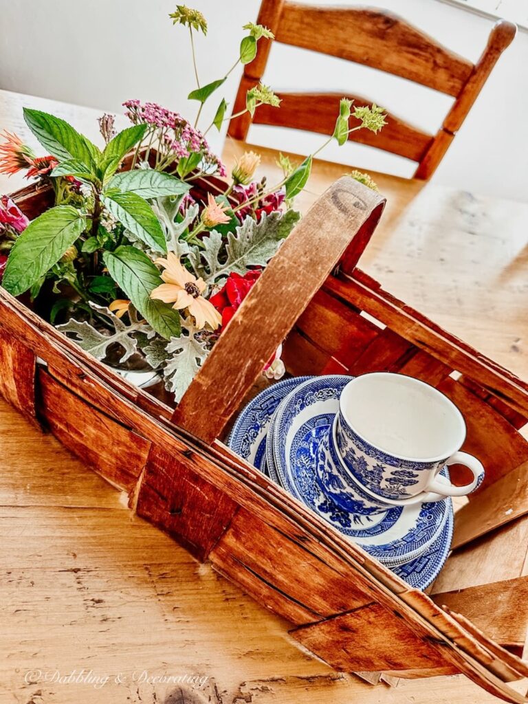 Old Basket with Flowers and Vintage Dishes