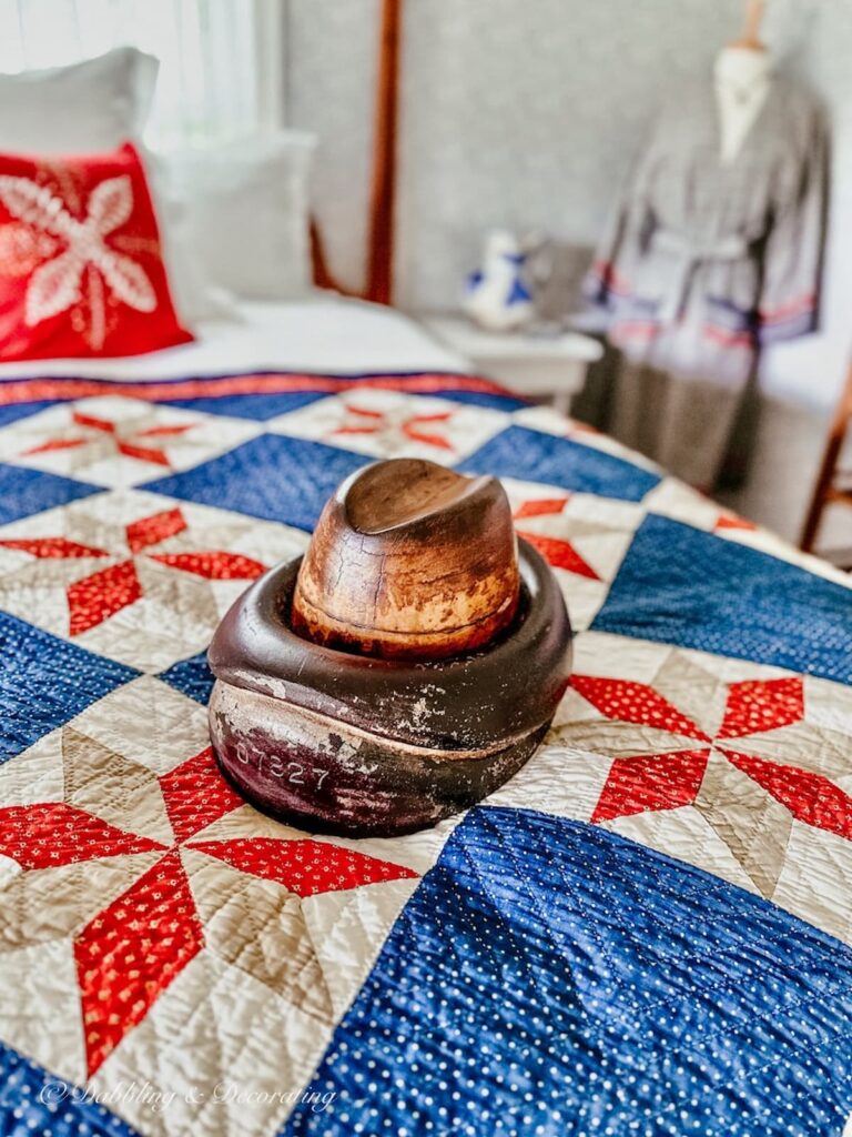 Antique Millinery Hat Mold on bed.