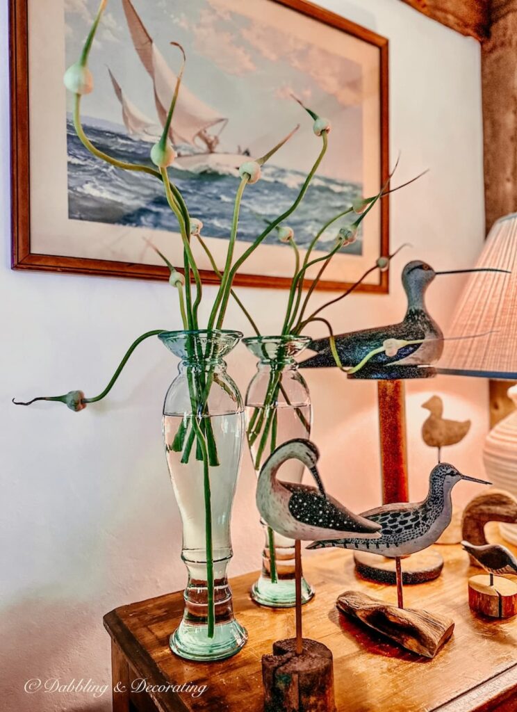 Nautical sea birds with garlic scapes in vases.