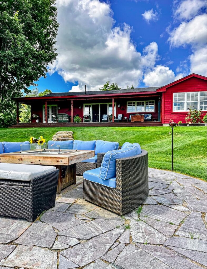 Red House with Fire Pit and outdoor Conversational Furniture.