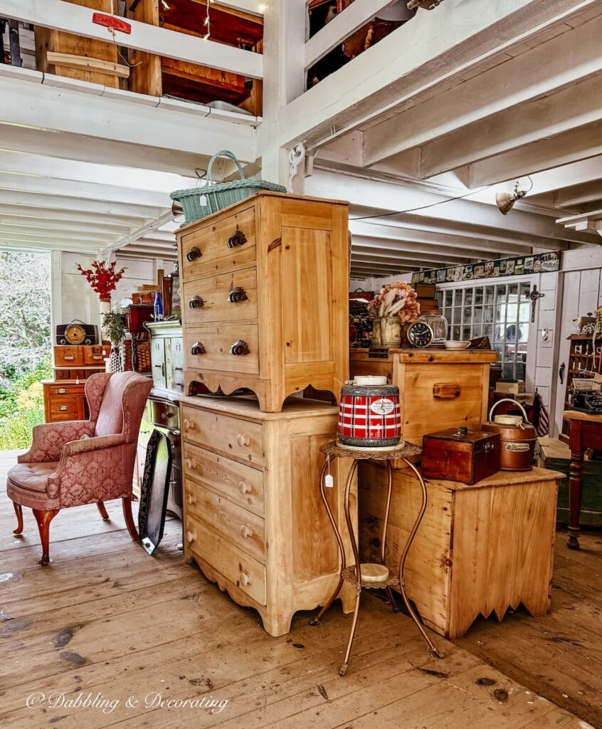 Inside the barn sale at Chandler & Co. in Berwick, Maine with stripped furniture stacked up.
