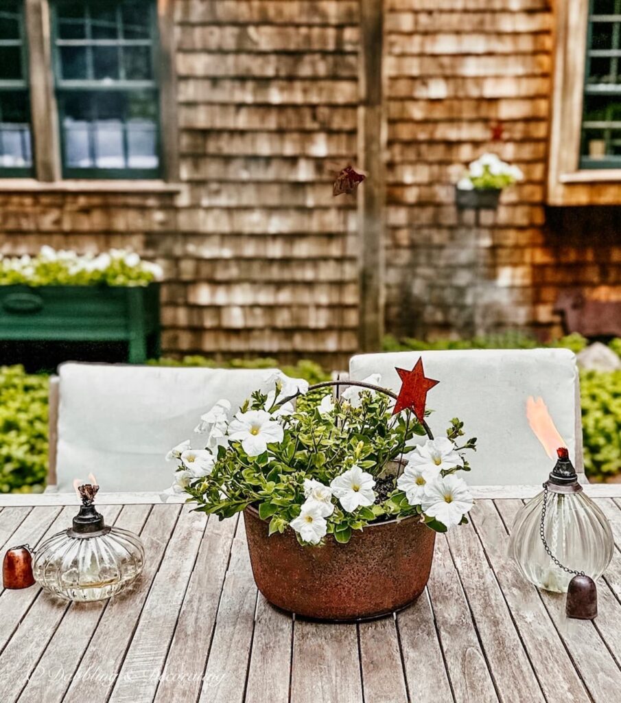 White Petunias Centerpiece in Wrought Iron Planter Pot