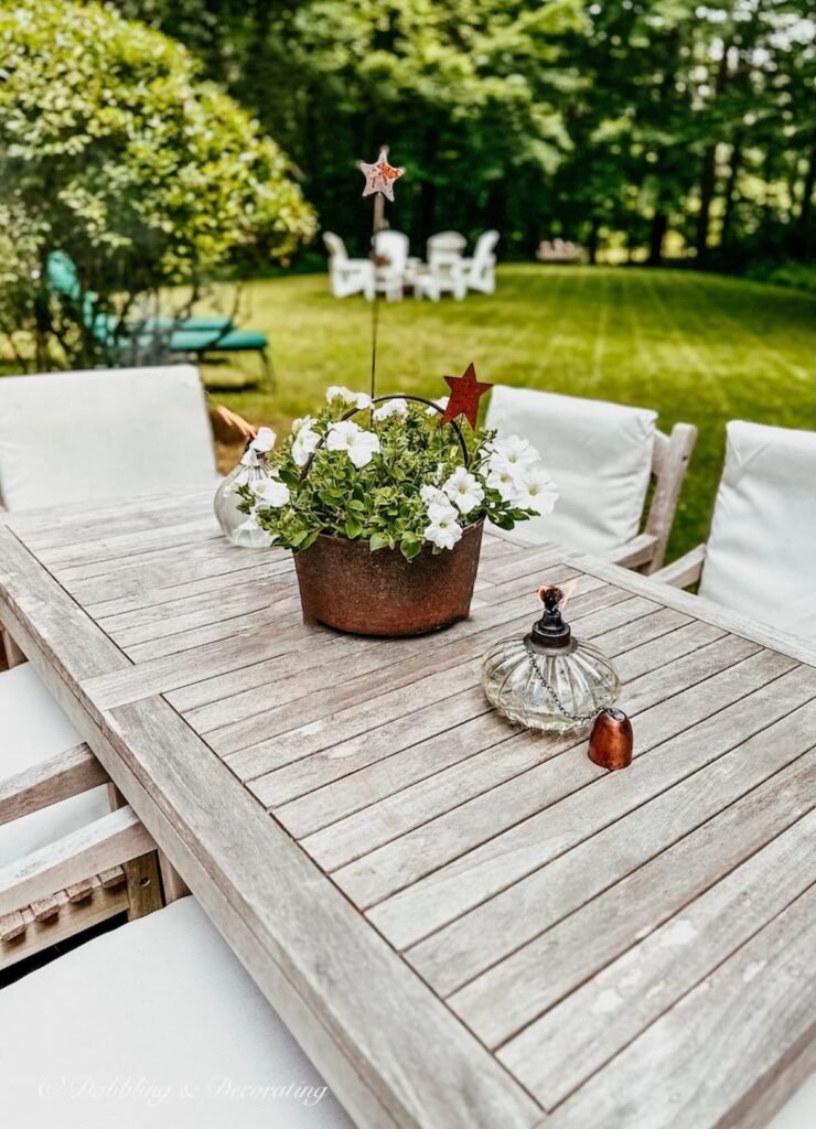 Outdoor Teak Table with Summer Flower Planter Centerpiece
