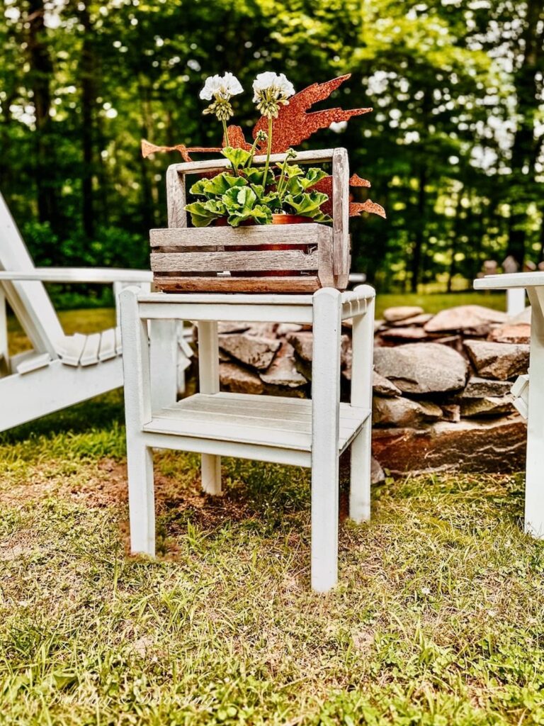 Clam Hod Roller with white petunias and rustic garden stake.