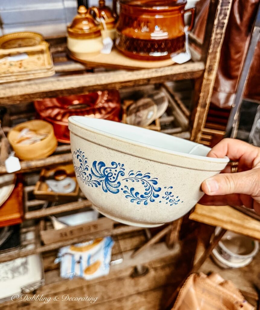 Brown and blue Pyrex bowl in hand at Waterfront Flea Market in Brunswick, Maine.