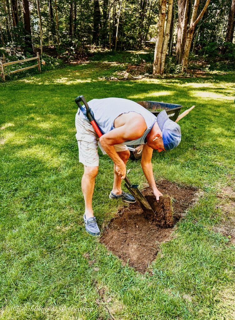 Man Removing Grass to build a pea gravel patio.