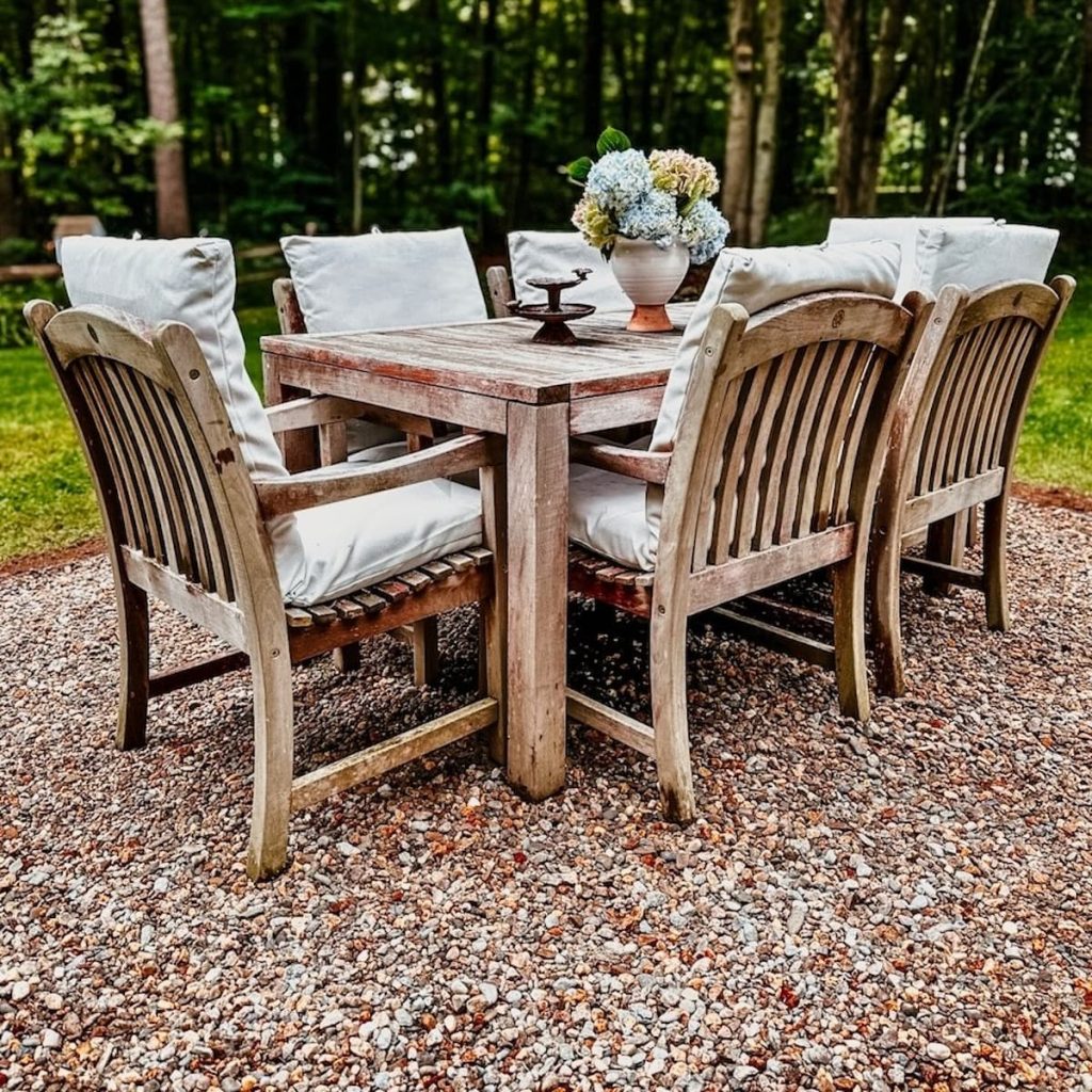 Pea Gravel Patio Ideas with Outdoor Teak Table Dining Space.