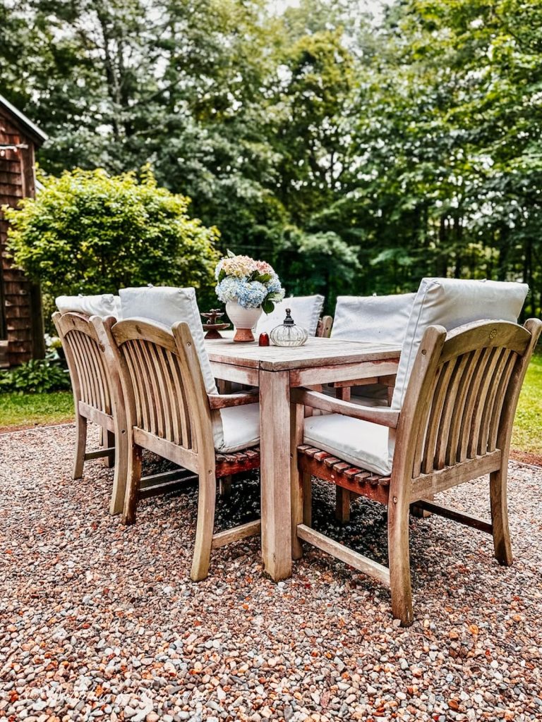 Outdoor Pea Stone Patio with Teak Table Setting