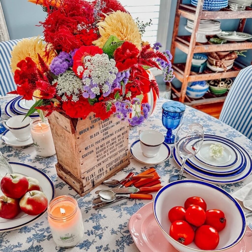 DIY Autumn flower arrangement in vintage crate on blue and white table centerpiece.