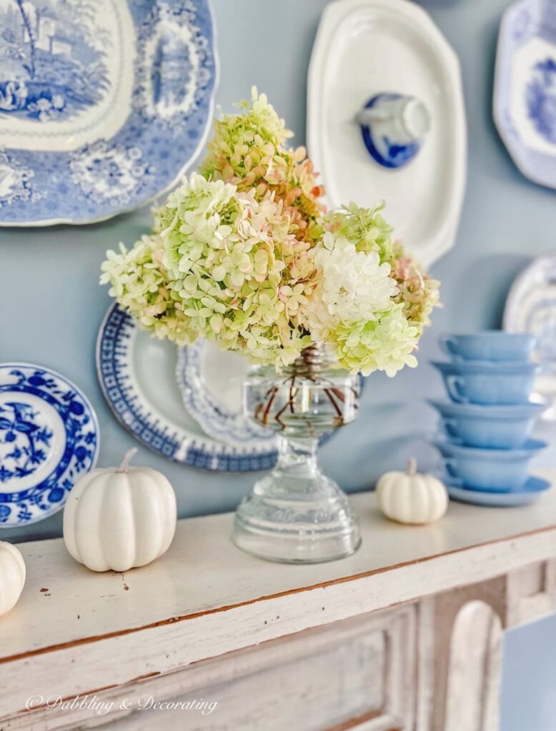 Fall hydrangeas in unique flowers vase on Mantel