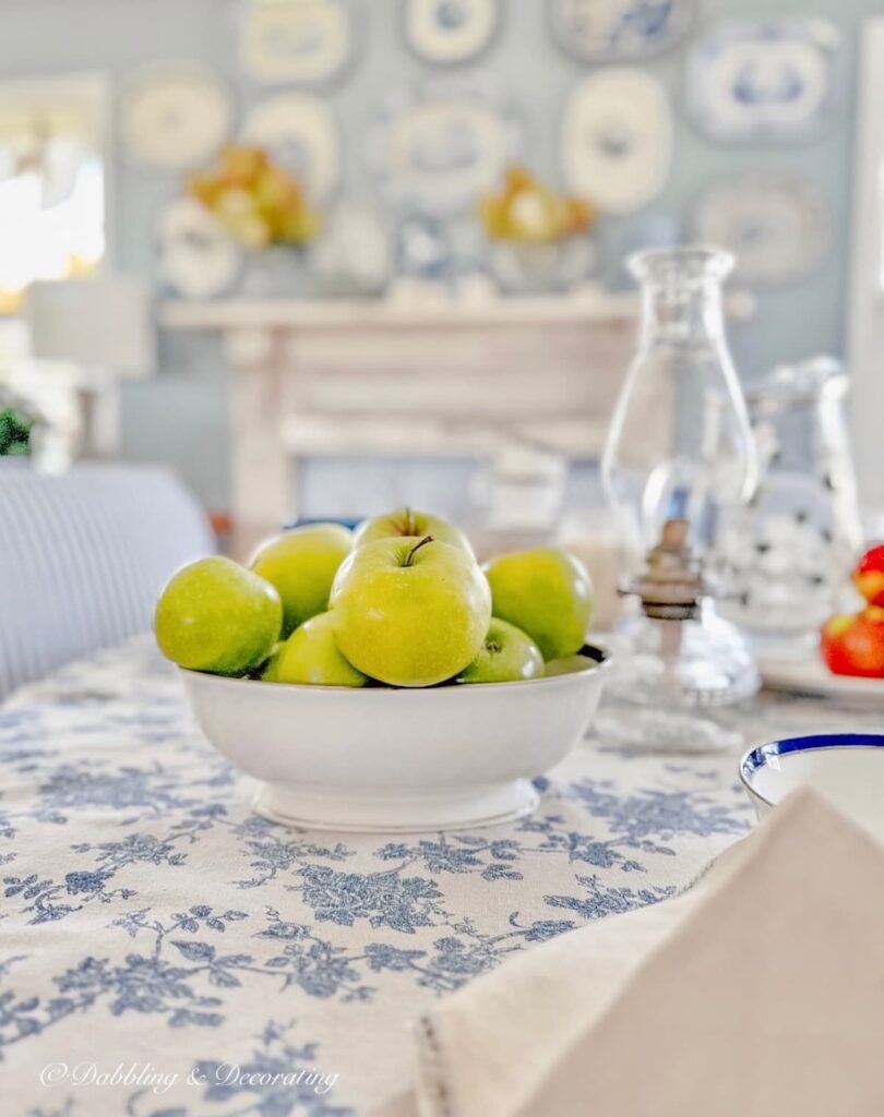 Bowl of Apples on Blue and White Table Setting