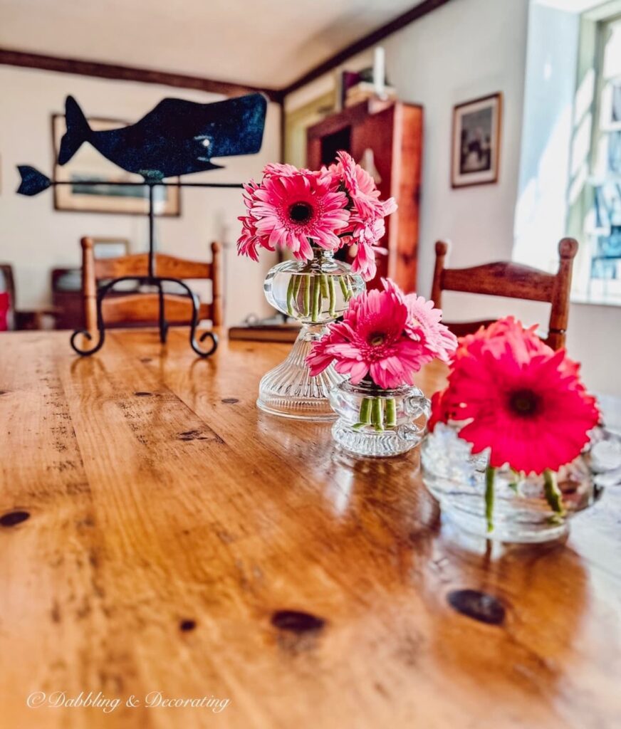 vintage oil lamps turned into unique flowers vase with pink flowers.