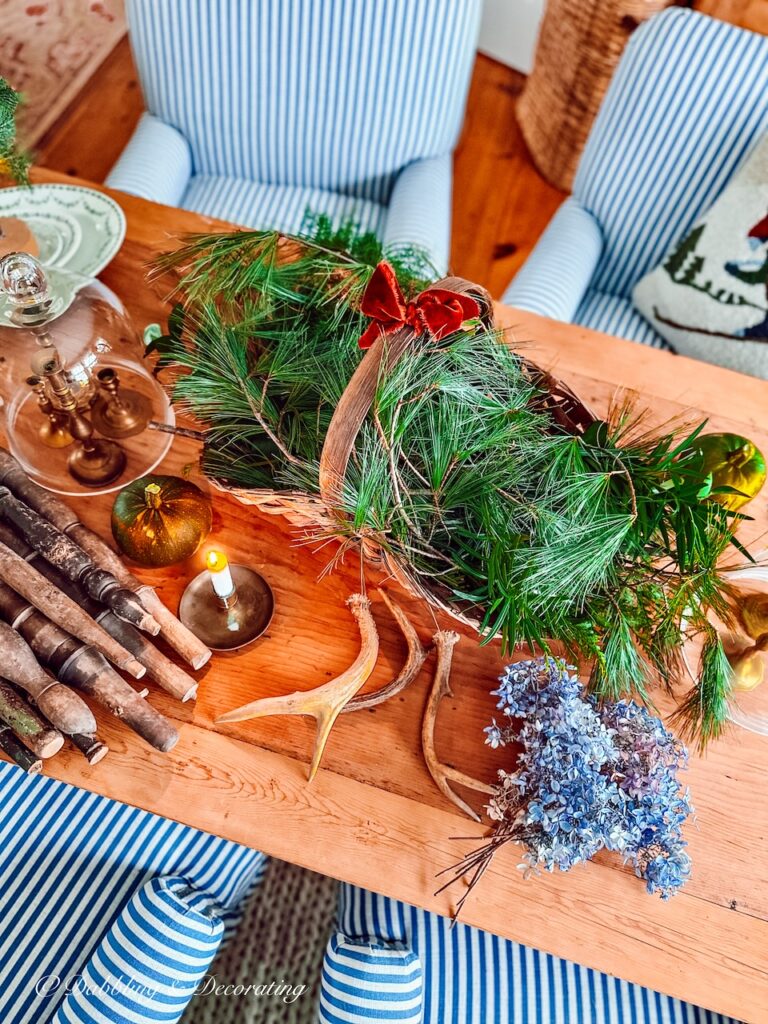 Basket of Antlers, evergreens, and blue hydrangeas