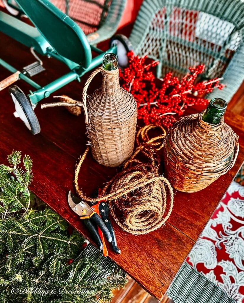 Demijohns with winterberries and evergreens