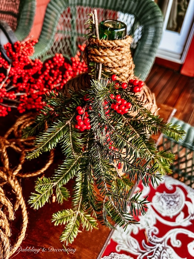 Demijohn bottle with winterberries and evergreens