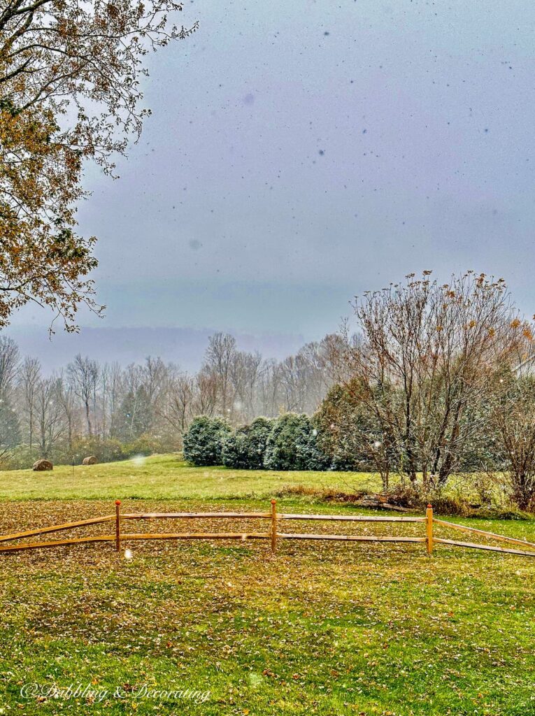 Snowfall in early November with split rail fencing, snowing and stick season in Vermont.