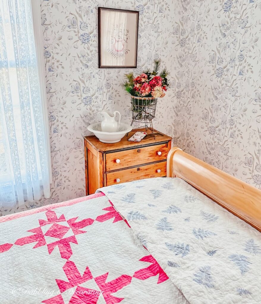 Sleigh Bed with Pink Quilt and Dresser