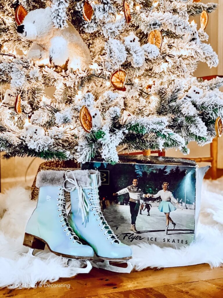 A festive Christmas tree adorned with a polar bear and a pair of ice skates, perfect for 12 Days of Christmas decorations.