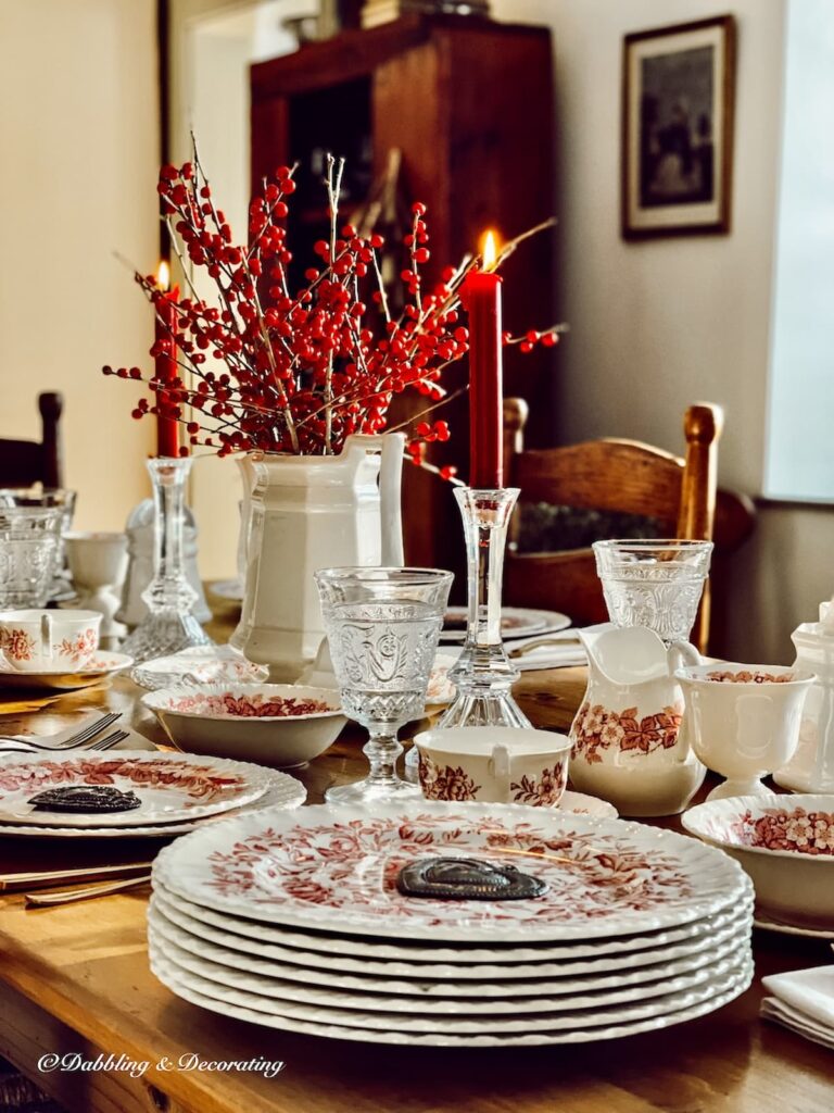 A festive Christmas table setting adorned with red and white dishes, perfectly embodying the spirit of the 12 Days of Christmas Decorations.