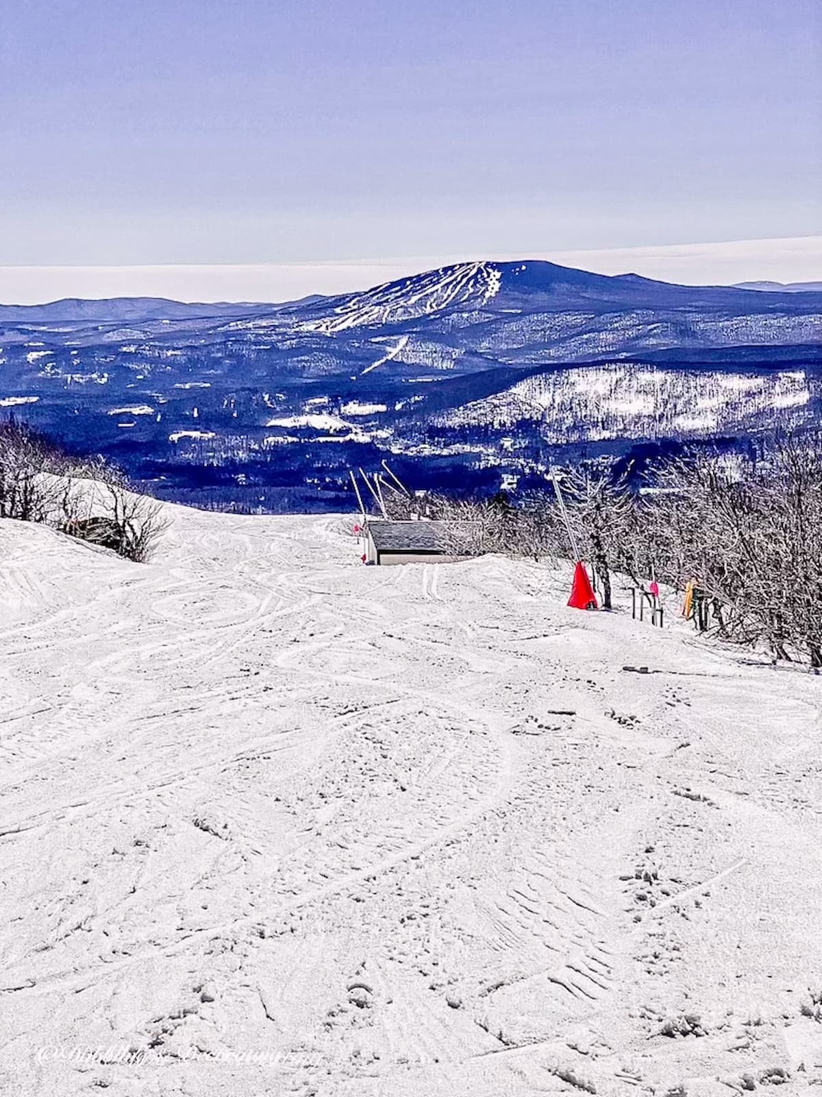 A skier is gracefully skiing down a snowy slope, creating a beautiful scene in the midst of serene cabin decor.