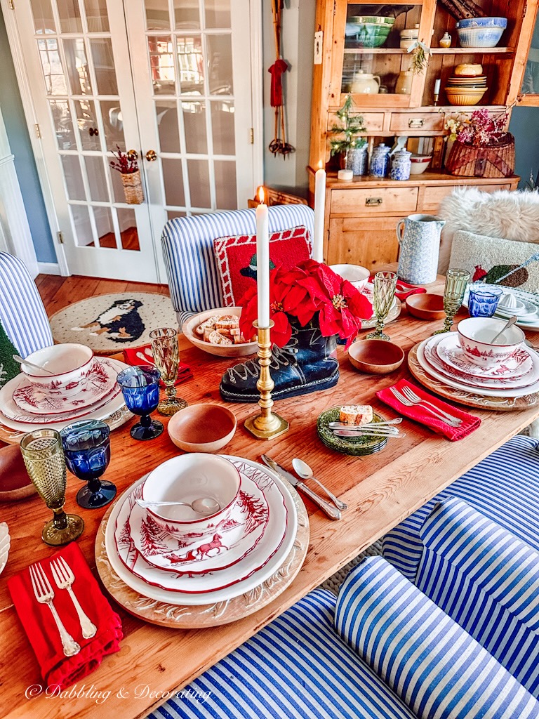 A cabin-inspired Christmas table setting with red and white plates.