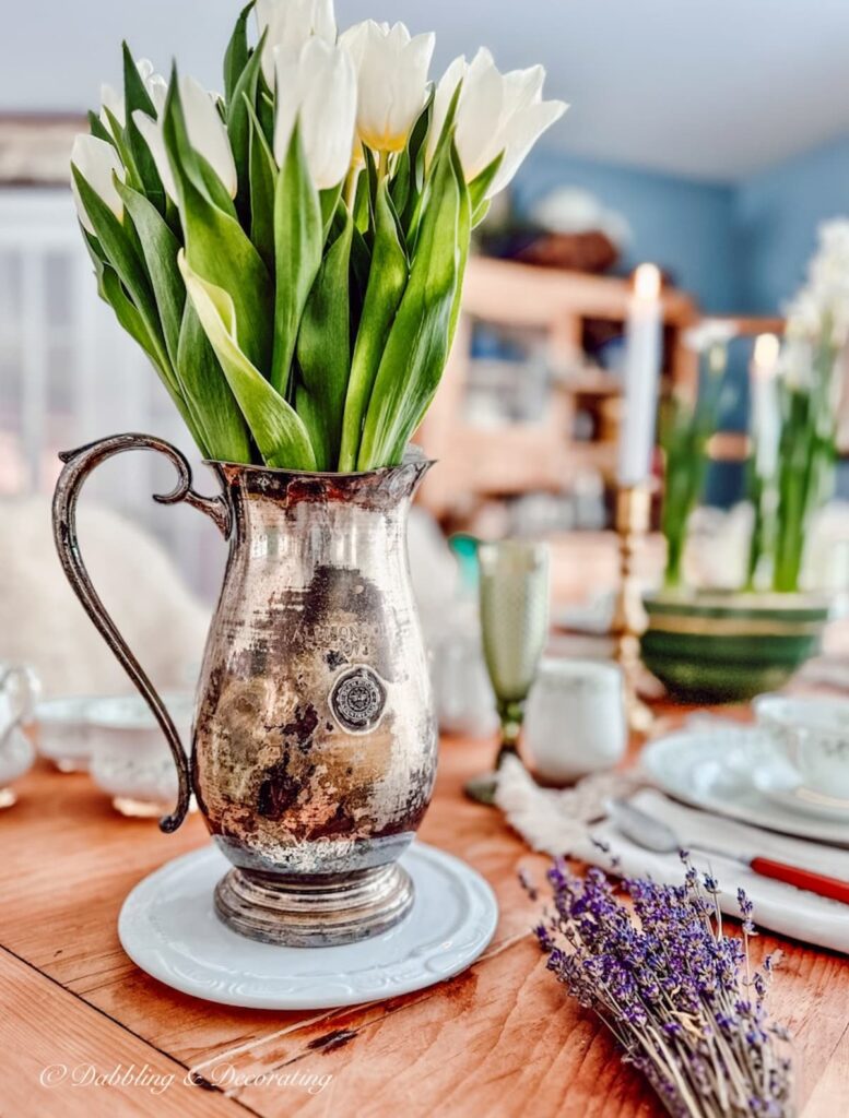 White tulip arrangement ideas in vintage silver pitcher.