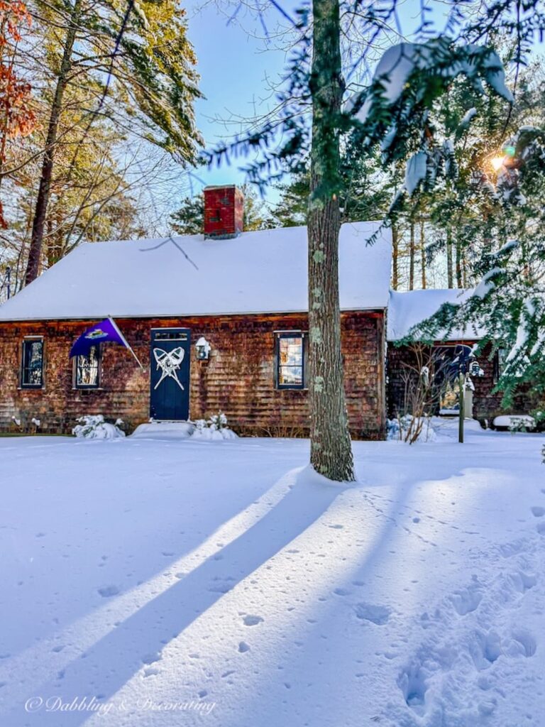 Cedar Shake Home in the Snow with Snowshoes on Front Door