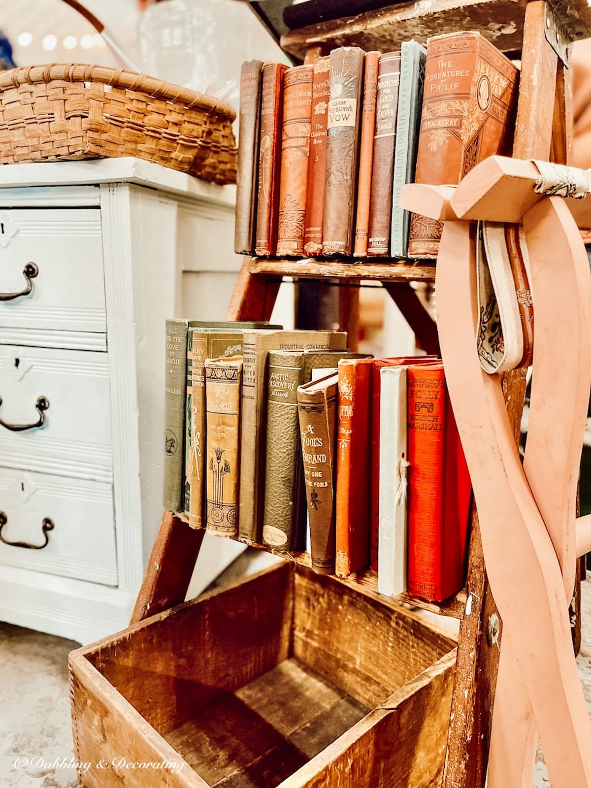 Old books stacked in vintage step stool.