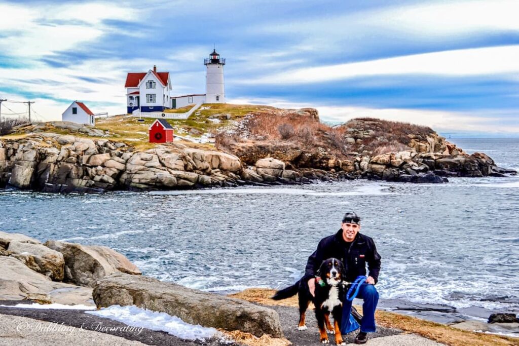 Man at Nubble Lighthouse with Bernese Mountain Dog