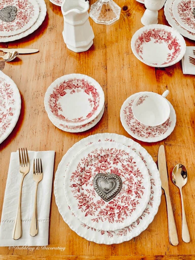 Pink and white thrifted place settings  for a warm winter tablescape.