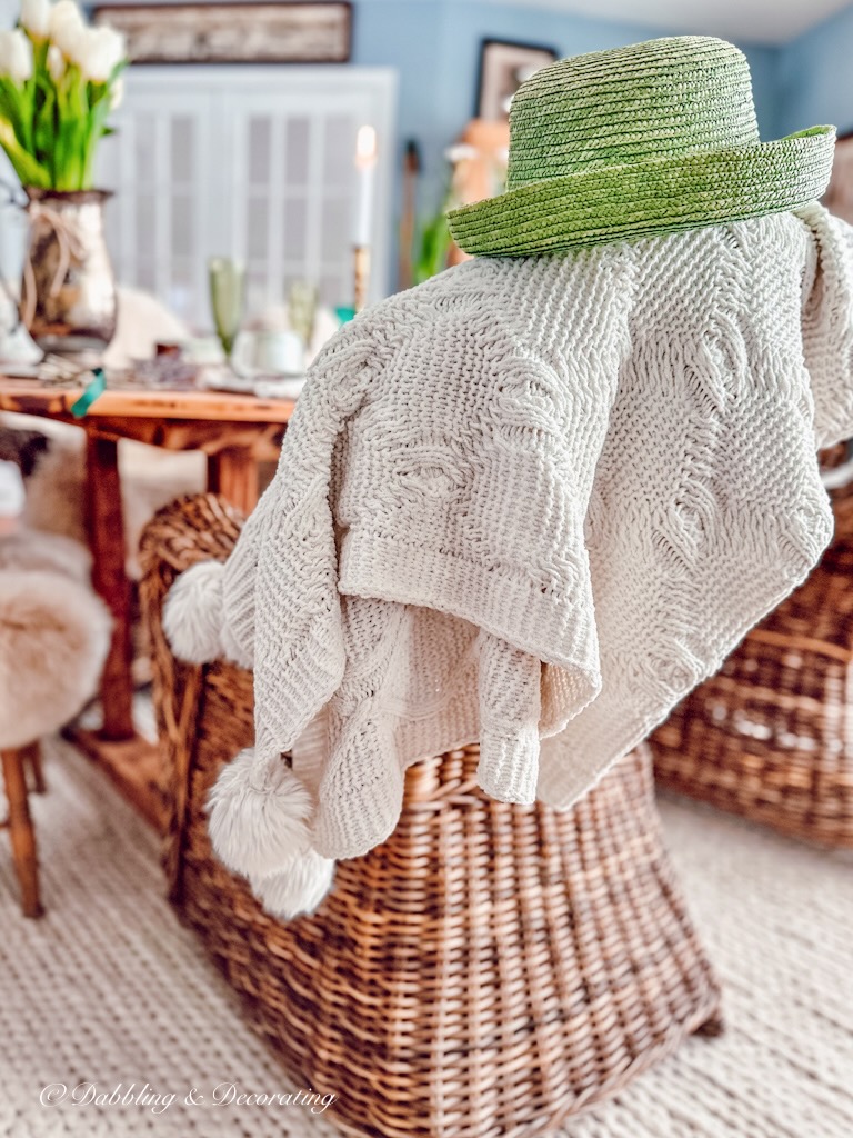 Green Irish Top Hat with Knitted Blanket on Wicker Chair