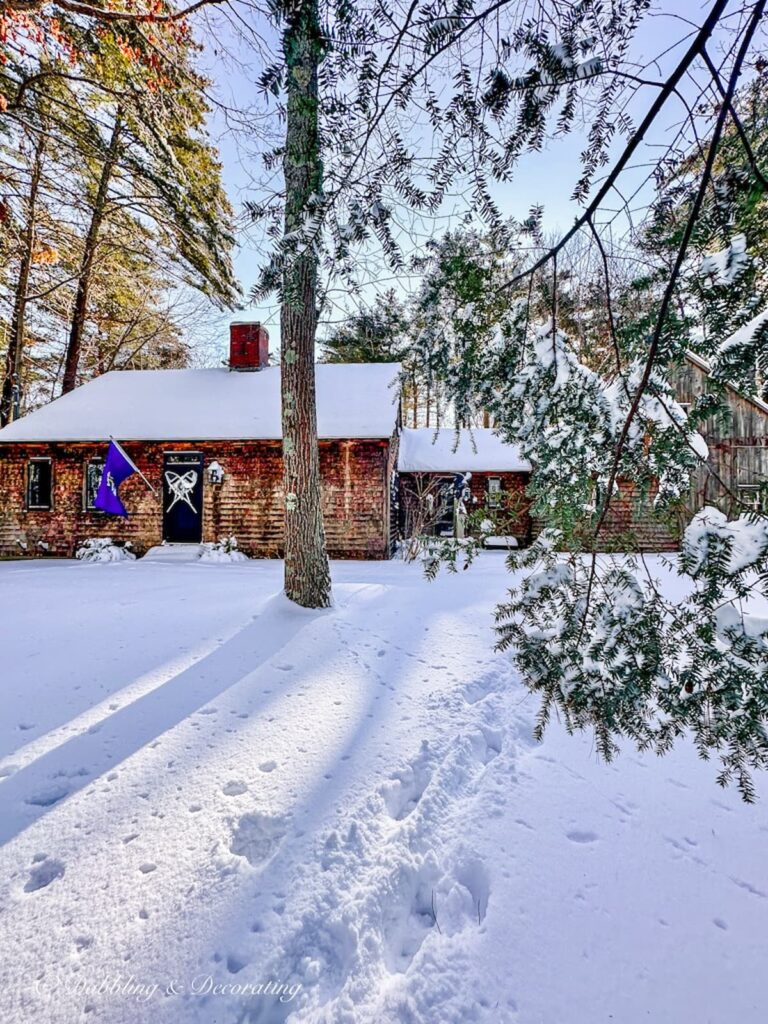 Cedar Shake Home in Snow with Snowshoes on Front Door