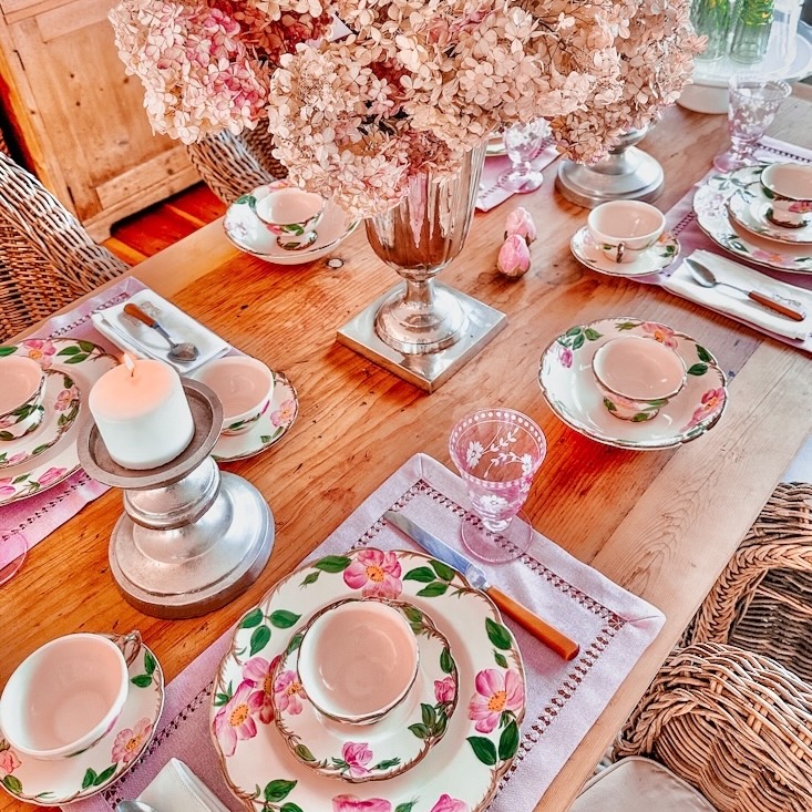 Vintage Galentine's Day table setting centerpiece on full tablecape with pink dried hydrangeas in large silver vesel.