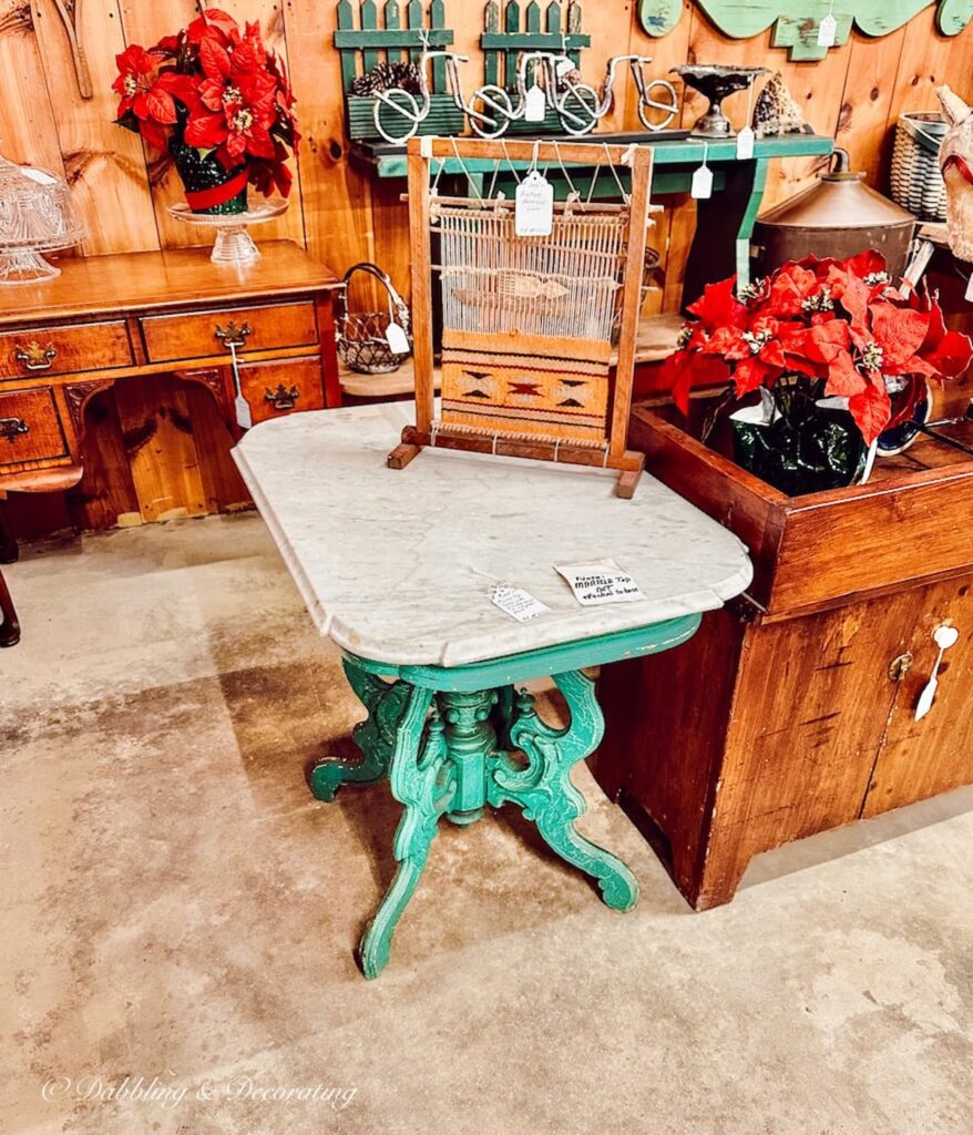 vintage green table with marble top in antique store.