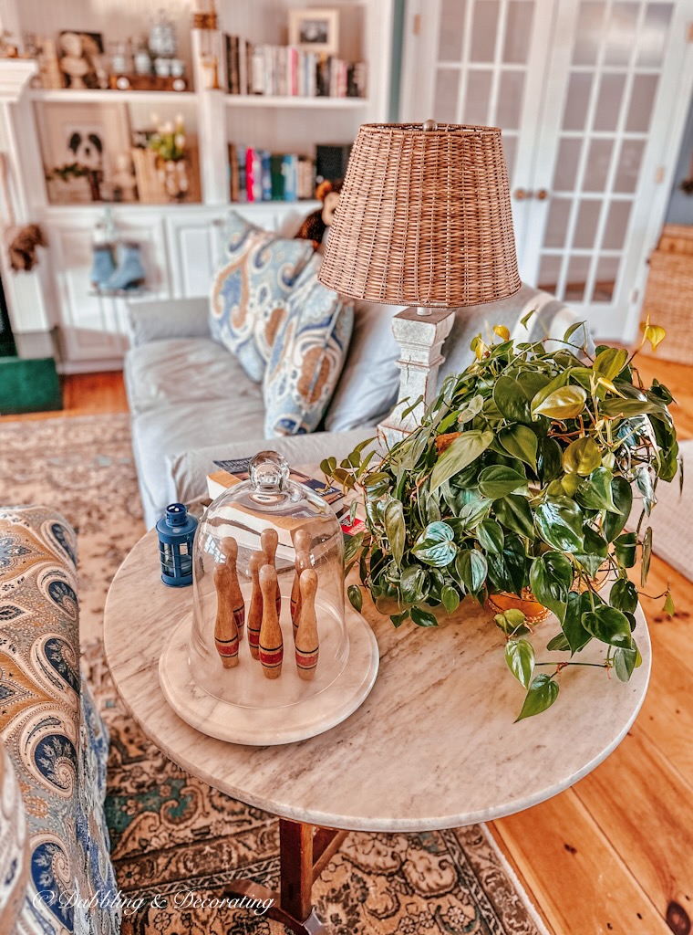 Marble side table with plant and vintage decor in living room