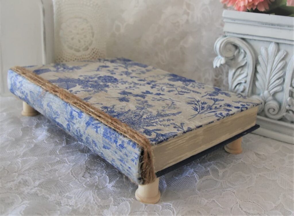 Vintage inspired blue and white riser in the form of an old book for blue and white gifts for hostess.