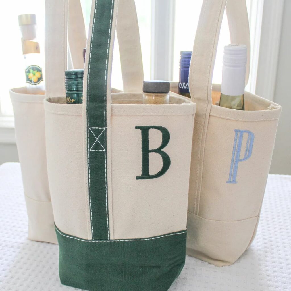 Personalized canvas wine tote with green and blue handles for blue and white gift ideas.