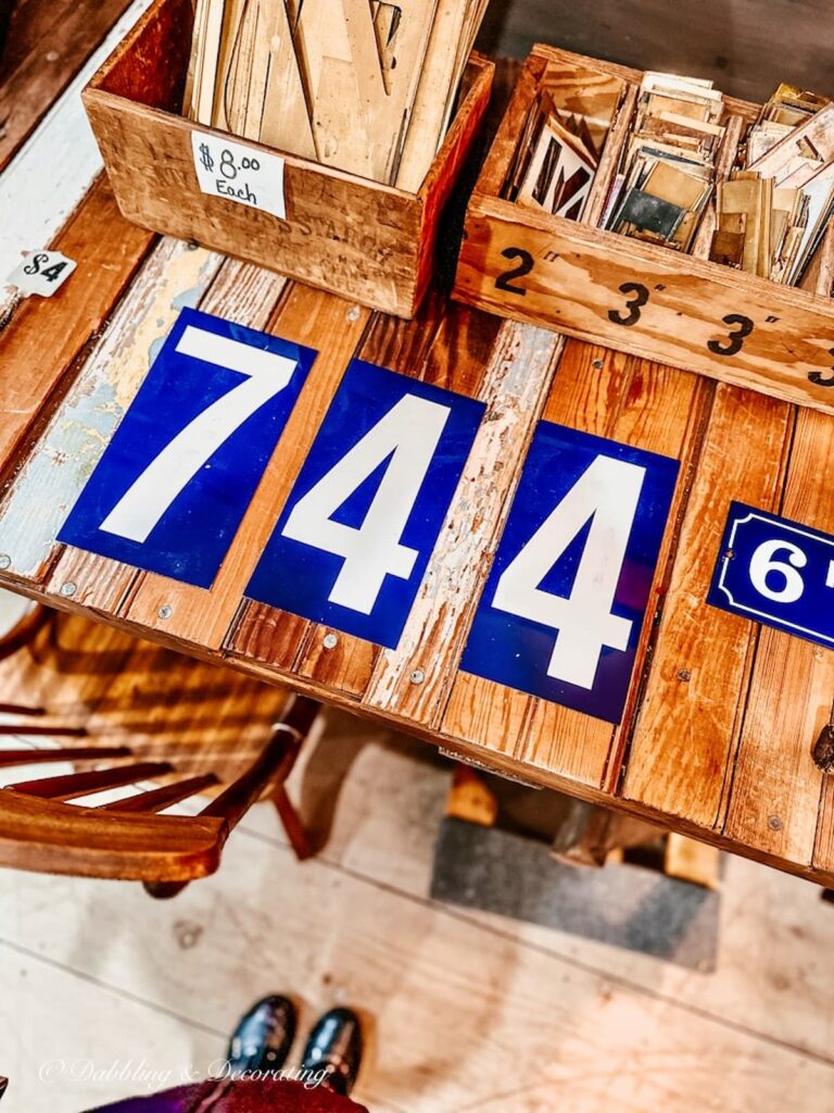 Blue and White Numbers on antique wooden table in shop.