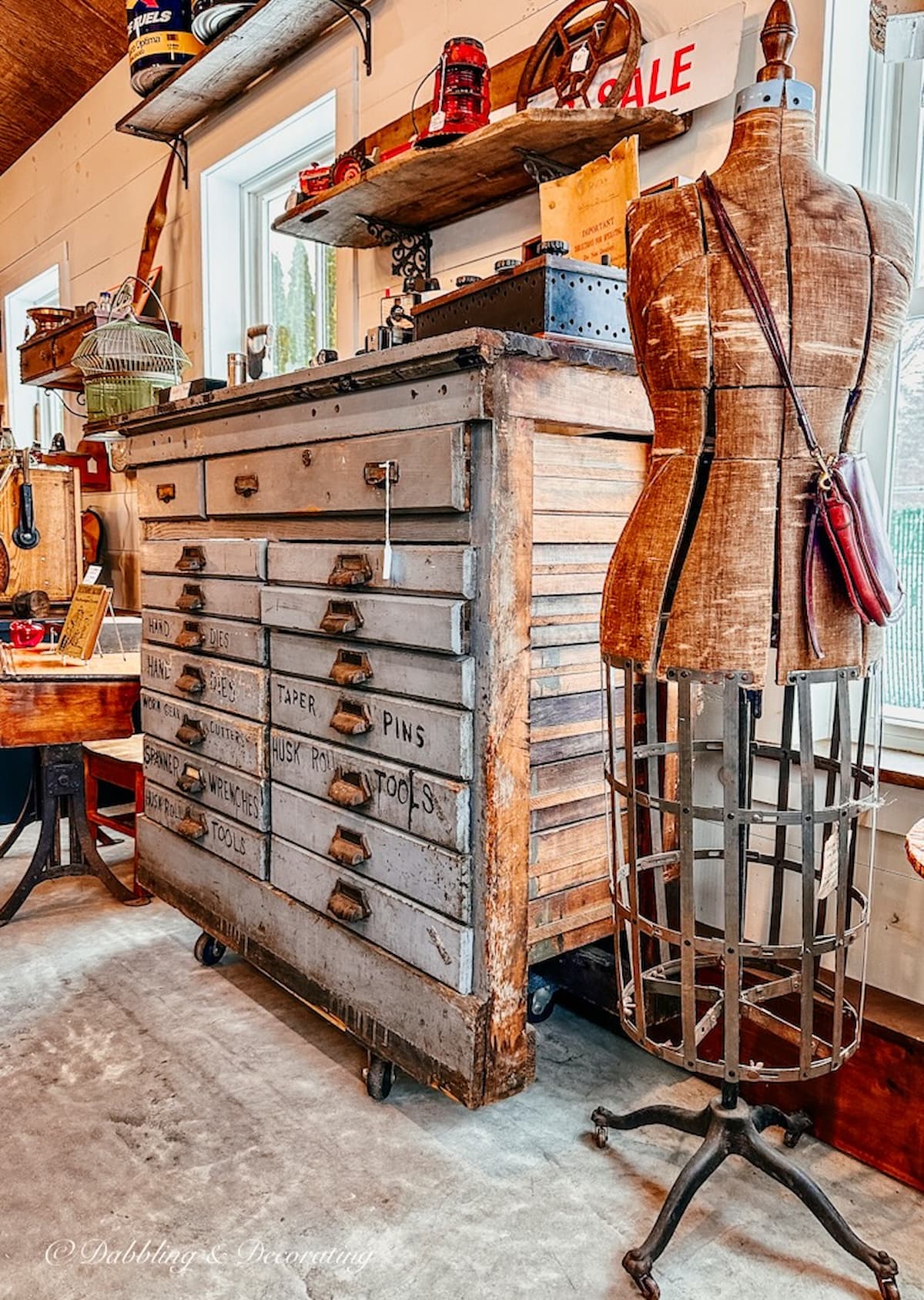Antique dress form mannequin in antique shop with vintage apothecary cabinet. Vintage Mannequin decoration ideas.