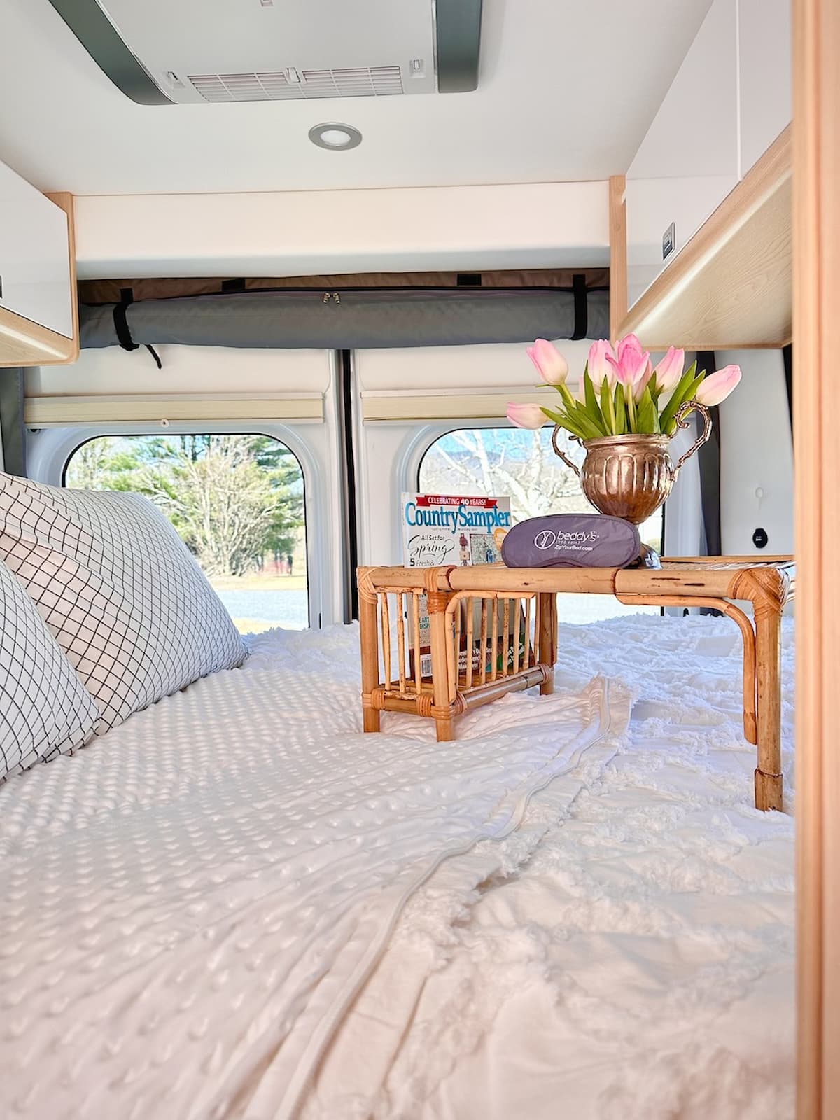 Best RV Bedding in Camper with bed tray and tulips.