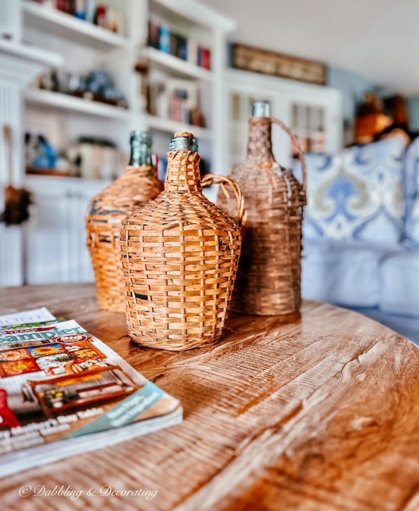 Three Demijohns and magazines on living room coffee table.