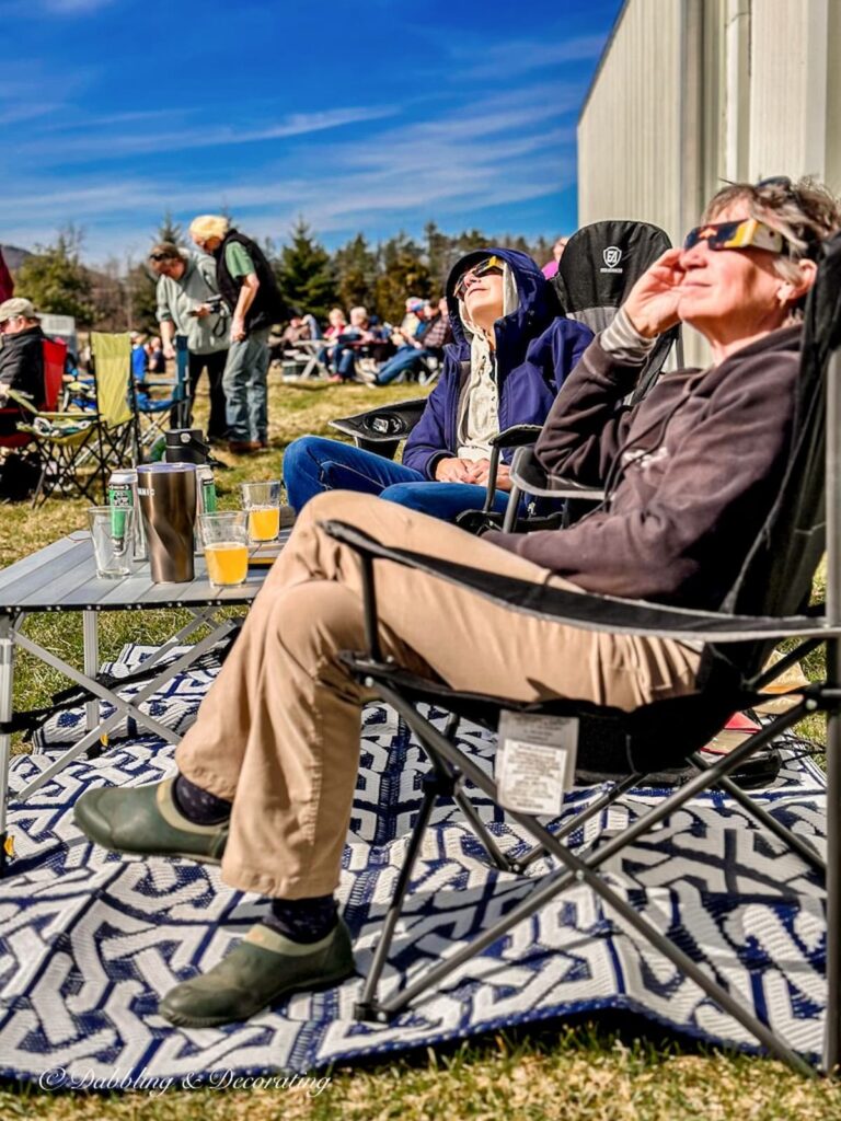Two women with eclipse glasses looking up to the sky.