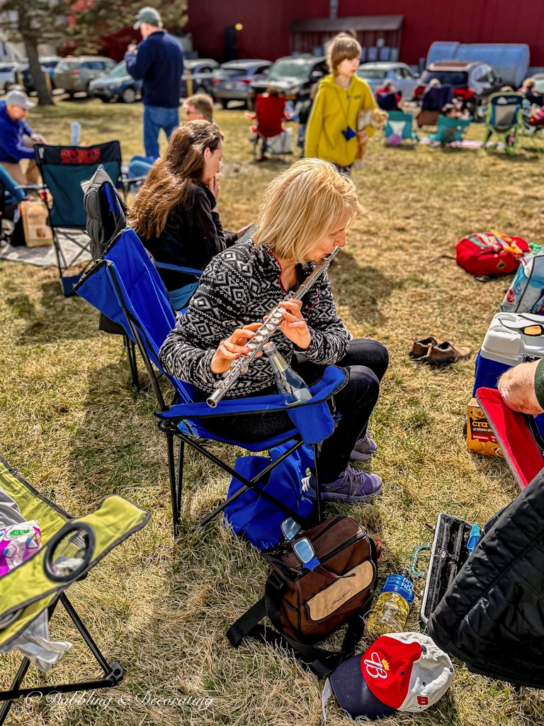 Woman playing flute at eclipse Vermont 2024.