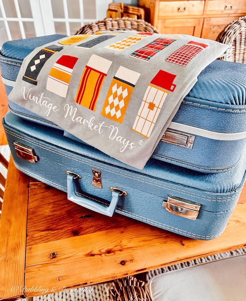 Two blue vintage suitcase shelves and vintage marketplace t shirt.