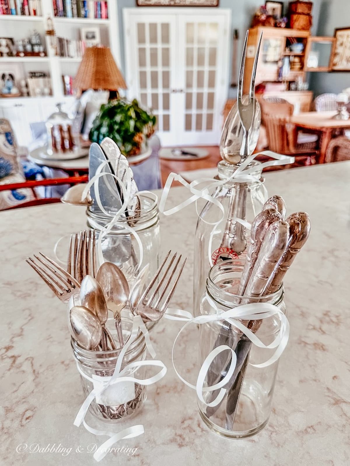 Vintage Silverware in Mason Jars on kitchen counter with white bows.