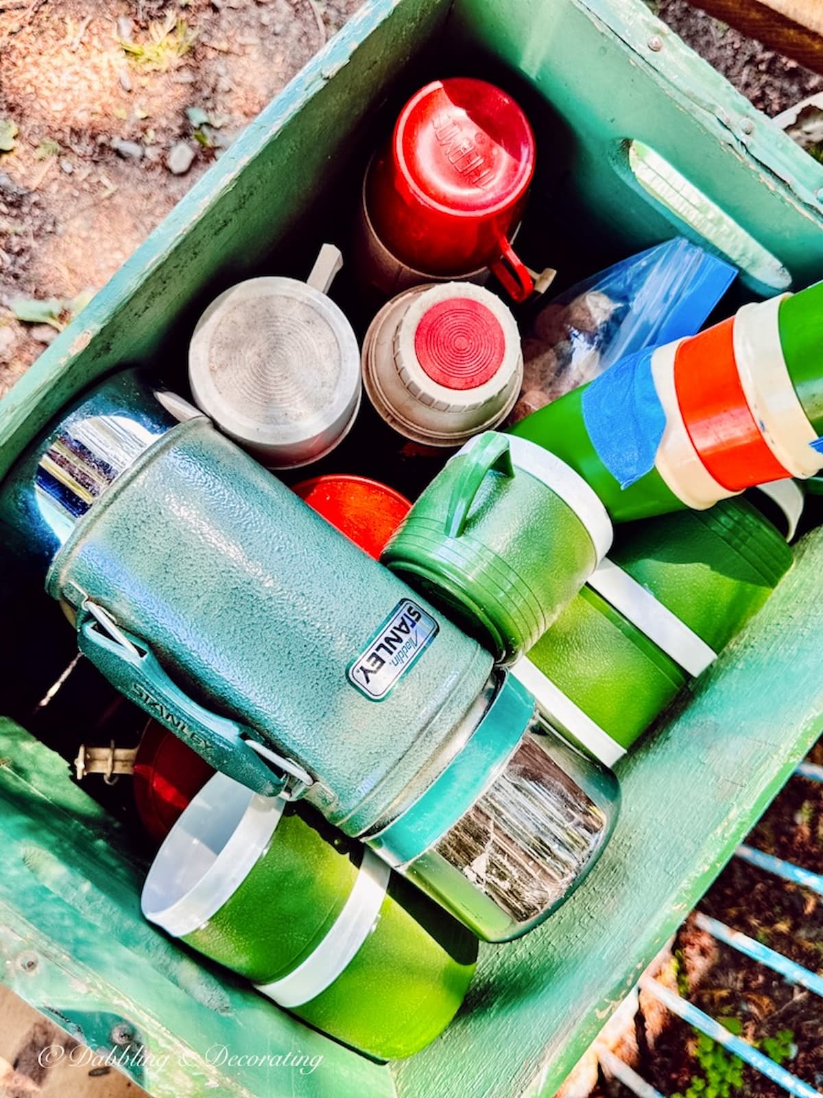 Colorful Vintage Thermoses in Box at an antique store.