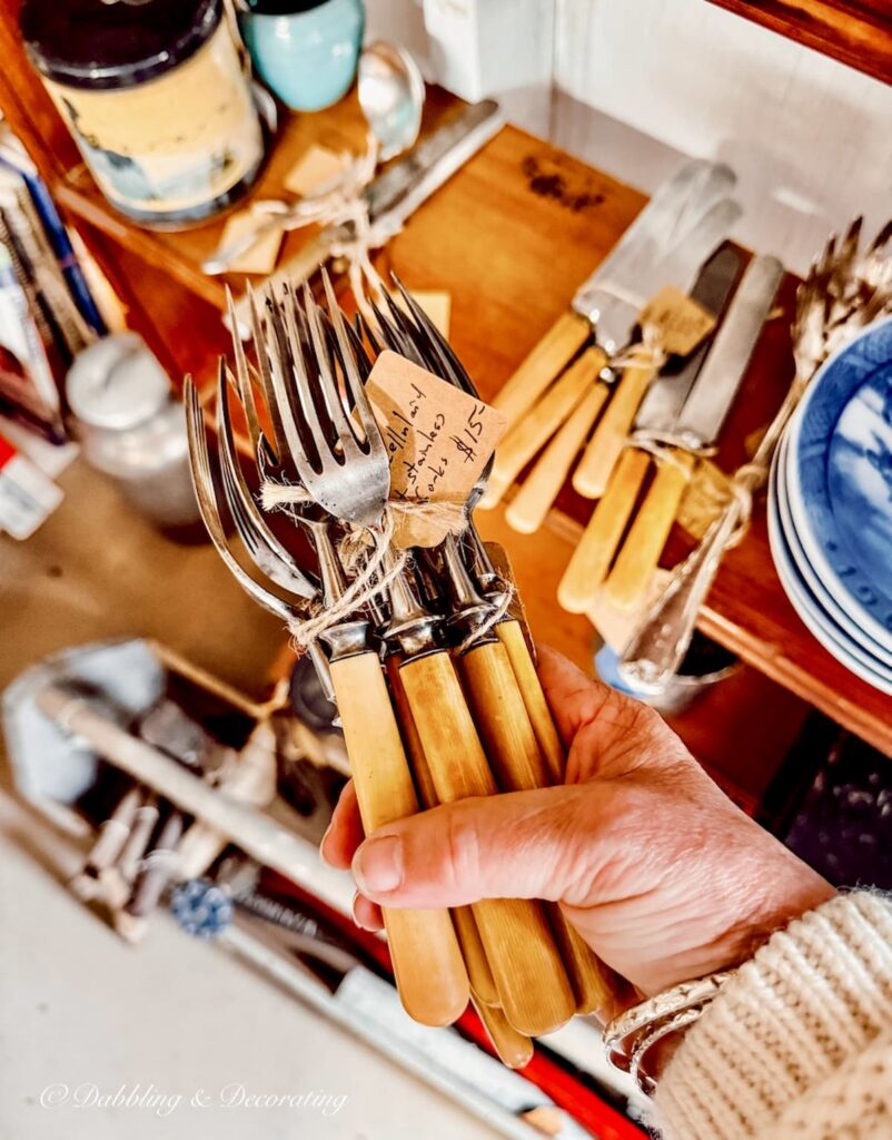 Vintage silverware with Bakelite handles in hand at Vintage Market Days Vermont.